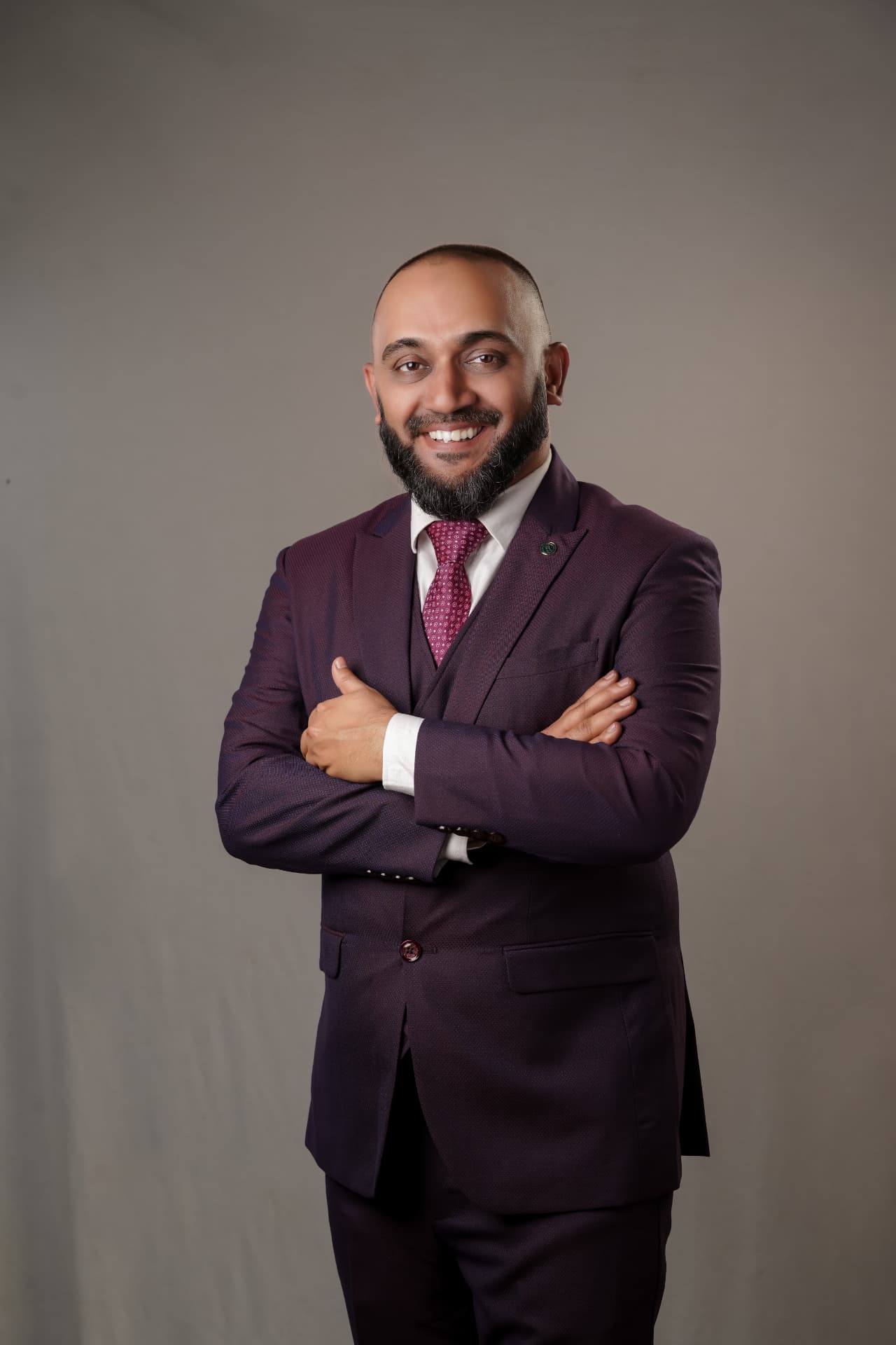 Portrait of Rafeeq Cherusseri in a purple three-piece suit